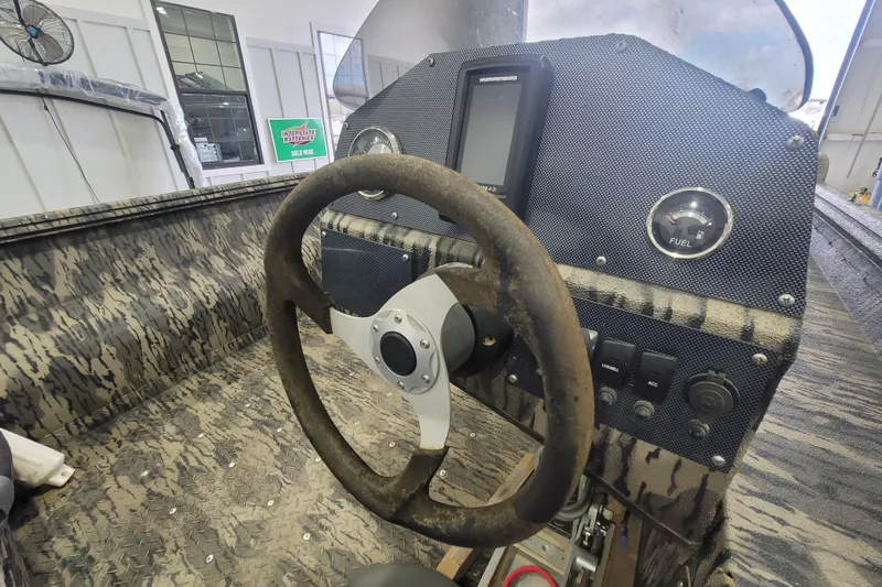 Slide: The Image of Steering console of 2023 Havac FRRSC boat with camouflage design and control panel. - 15