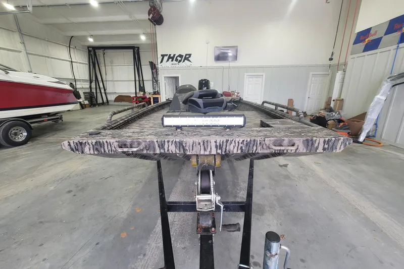 Slide: The Image of Boat in a workshop, featuring a 2023 Havac FRRSC model, with a camouflage pattern. - 3