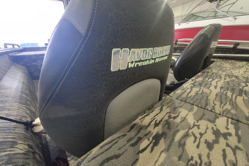 Slide: The Image of Interior of 2023 Havac FRRSC boat with camo seats and "Havoc Boats" logo. - 7