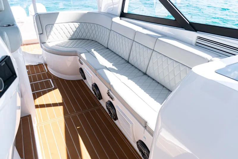 Slide: The Image of Luxurious seating on 2018 Intrepid 438 Evolution yacht with quilted upholstery and wooden flooring. - 17