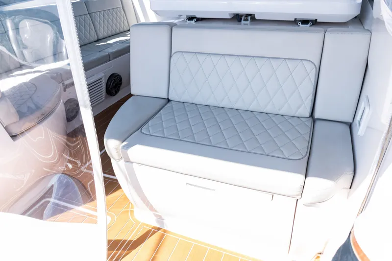 Slide: The Image of Luxurious seating on 2018 Intrepid 438 Evolution yacht with quilted upholstery and wooden flooring. - 19
