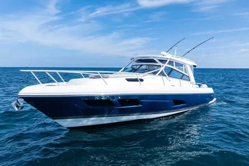 Slide: The Image of 2018 Intrepid 438 Evolution yacht cruising on open water under a clear sky. - 2