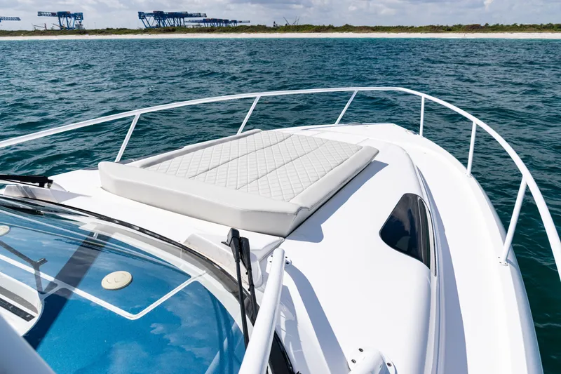 Slide: The Image of 2018 Intrepid 438 Evolution boat with sun pad on open water. - 20