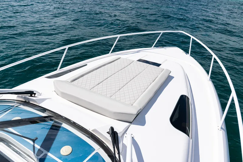 Slide: The Image of 2018 Intrepid 438 Evolution boat with cushioned deck, cruising on blue ocean waters. - 21
