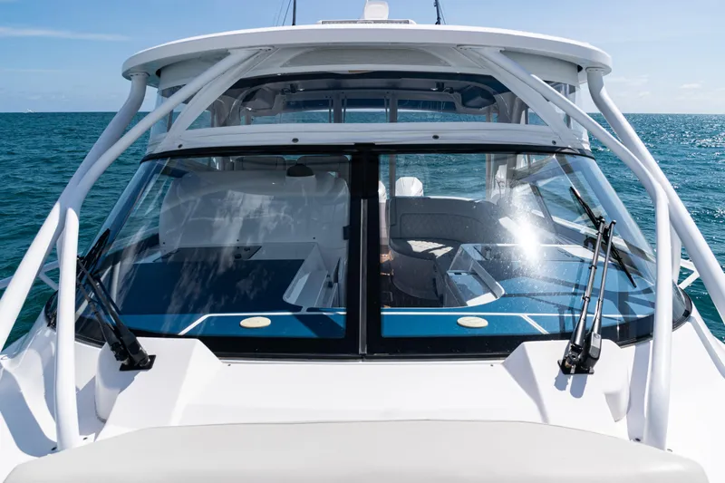 Slide: The Image of 2018 Intrepid 438 Evolution yacht on open sea, showcasing sleek design and spacious cockpit. - 23