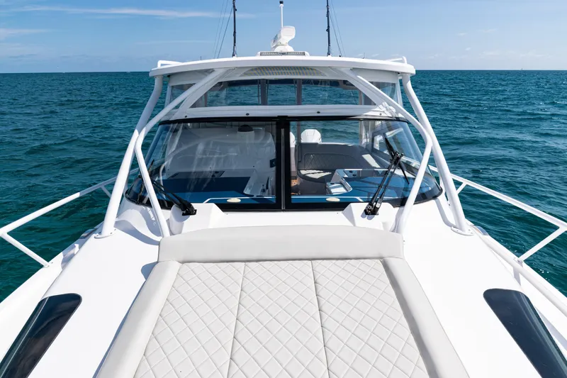 Slide: The Image of 2018 Intrepid 438 Evolution yacht cruising on open sea, showcasing sleek design. - 24