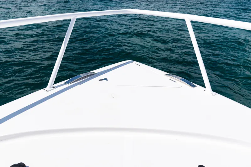 Slide: The Image of Bow view of 2018 Intrepid 438 Evolution yacht on open water. - 25