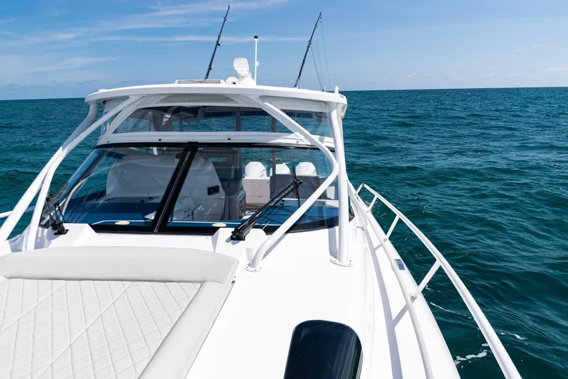 Slide: The Image of 2018 Intrepid 438 Evolution yacht cruising on open sea under clear skies. - 26