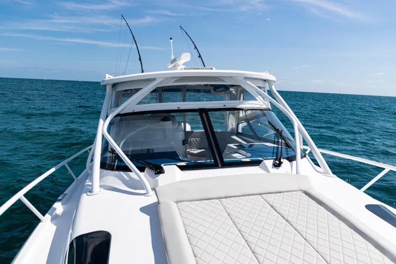 Slide: The Image of 2018 Intrepid 438 Evolution yacht cruising on open sea under clear blue sky. - 27