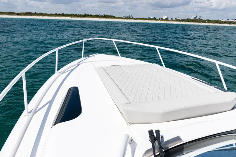 Slide: The Image of Bow view of 2018 Intrepid 438 Evolution yacht on open water. - 28