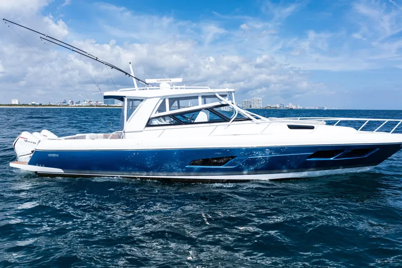 Slide: The Image of 2018 Intrepid 438 Evolution boat cruising on open water under a clear blue sky. - 3