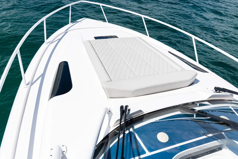 Slide: The Image of 2018 Intrepid 438 Evolution boat deck with sunpad, surrounded by ocean water. - 30