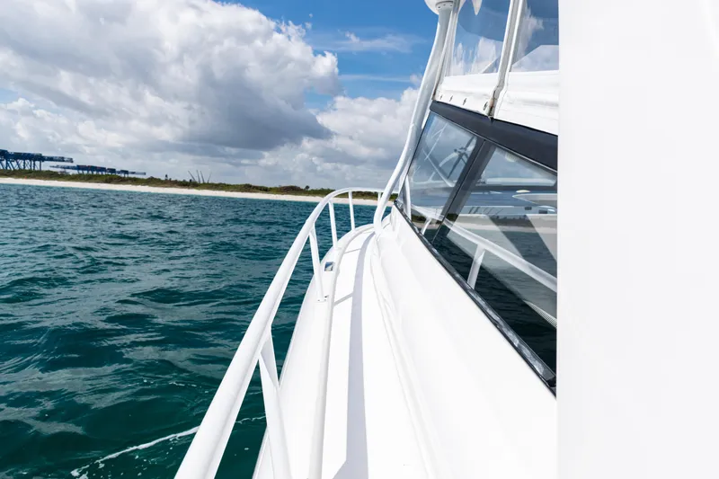 Slide: The Image of 2018 Intrepid 438 Evolution yacht cruising on open water under a cloudy sky. - 31