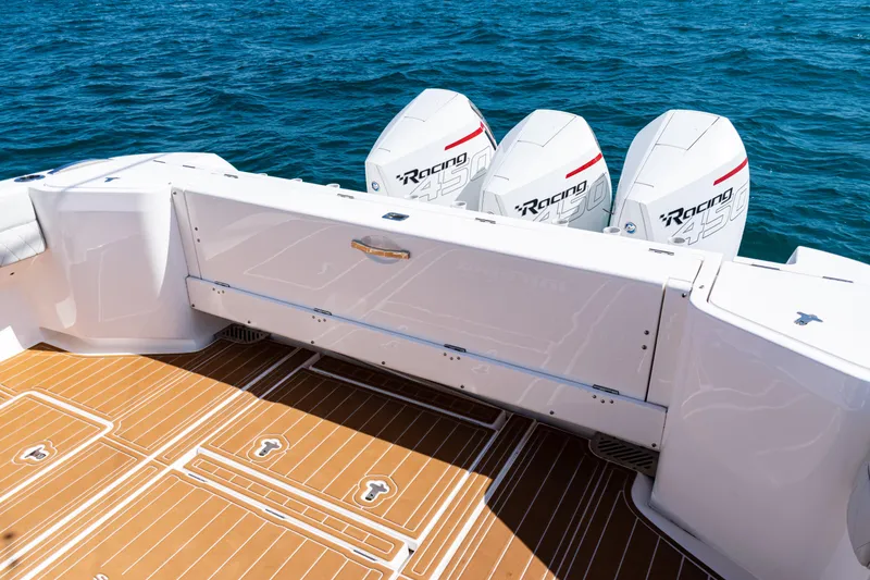 Slide: The Image of 2018 Intrepid 438 Evolution boat with triple Racing 450 engines on blue water. - 32