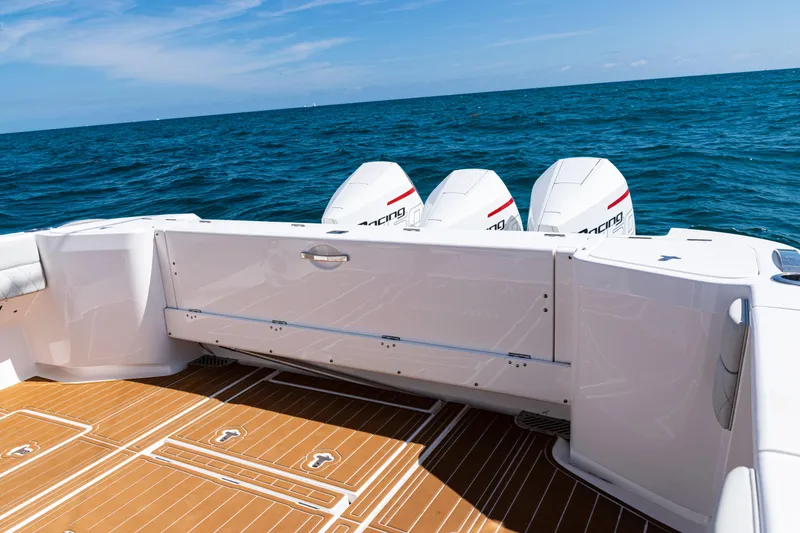 Slide: The Image of 2018 Intrepid 438 Evolution boat with triple outboard engines on open sea. - 34