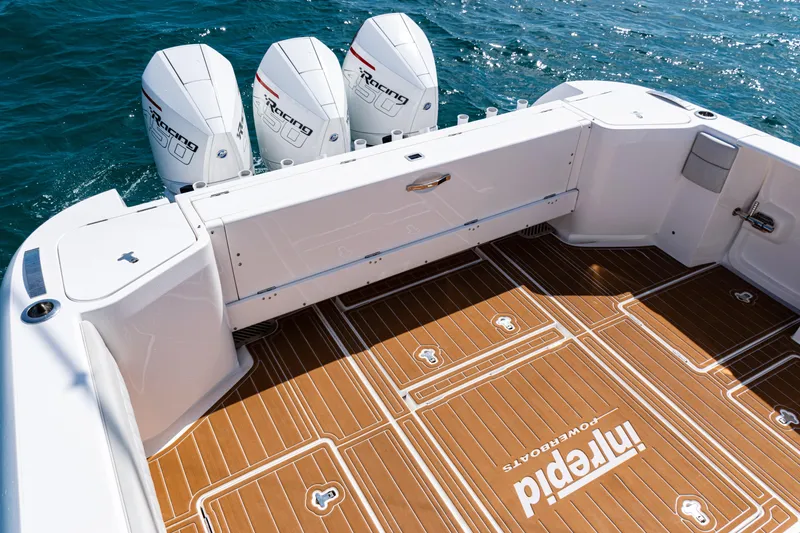 Slide: The Image of 2018 Intrepid 438 Evolution boat deck with triple outboard engines on the ocean. - 35