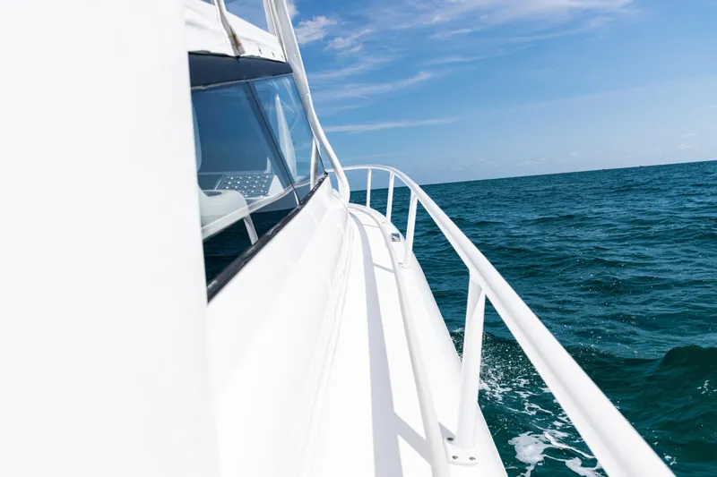 Slide: The Image of 2018 Intrepid 438 Evolution yacht cruising on open sea under clear blue sky. - 42