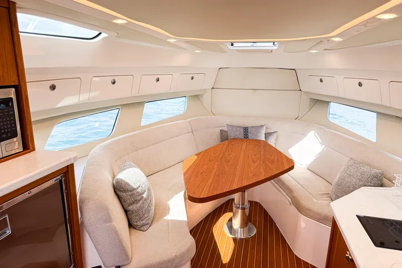 Slide: The Image of Luxurious interior of 2018 Intrepid 438 Evolution yacht with elegant seating and wooden table. - 48