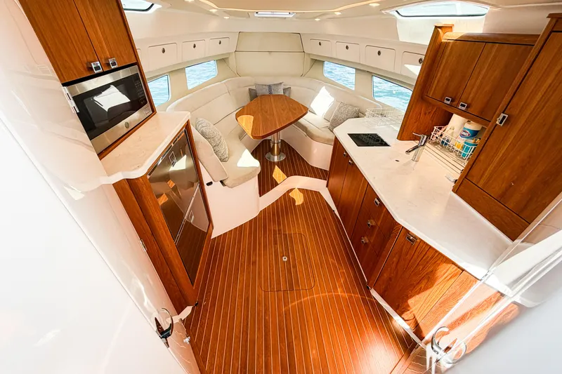Slide: The Image of Luxurious 2018 Intrepid 438 Evolution yacht interior with modern kitchen and cozy seating area. - 49