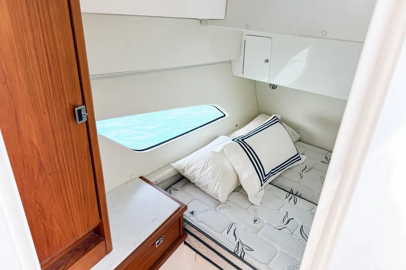 Slide: The Image of Cozy cabin interior of 2018 Intrepid 438 Evolution yacht with bed and window view. - 54