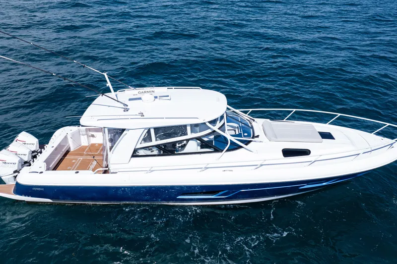 Slide: The Image of 2018 Intrepid 438 Evolution boat cruising on open water, featuring sleek design and powerful engines. - 7