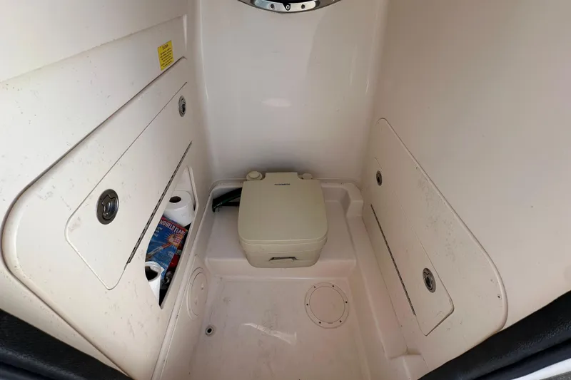 Slide: The Image of 2020 Grady-White Fisherman 236 boat interior with storage and portable toilet. - 13