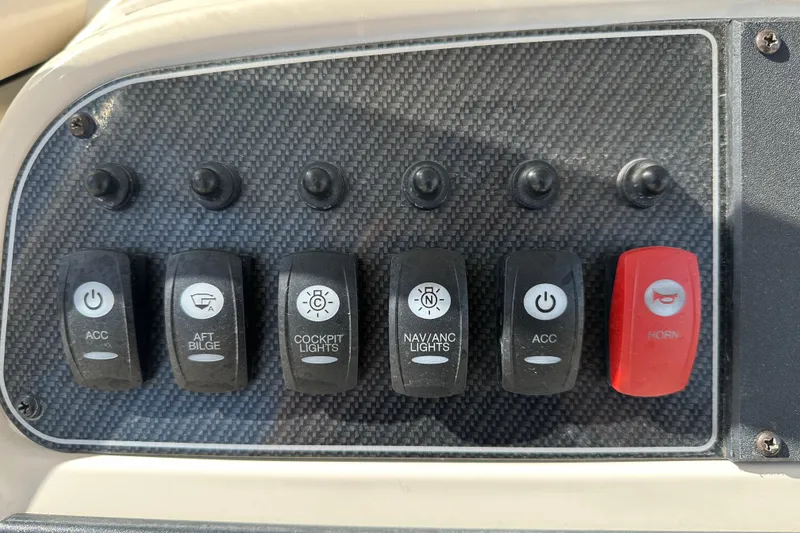 Slide: The Image of Control panel of a 2020 Grady-White Fisherman 236 boat with labeled switches. - 18
