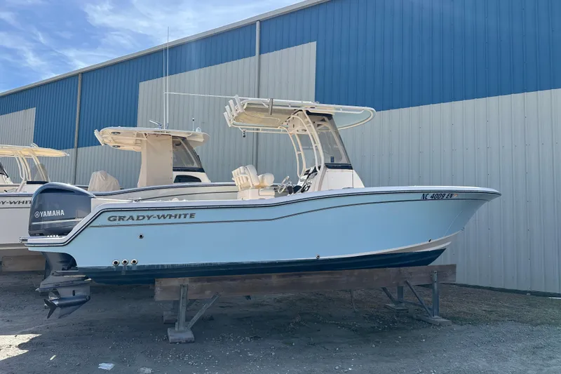 Slide: The Image of 2020 Grady-White Fisherman 236 boat with Yamaha engine, displayed outdoors. - 2