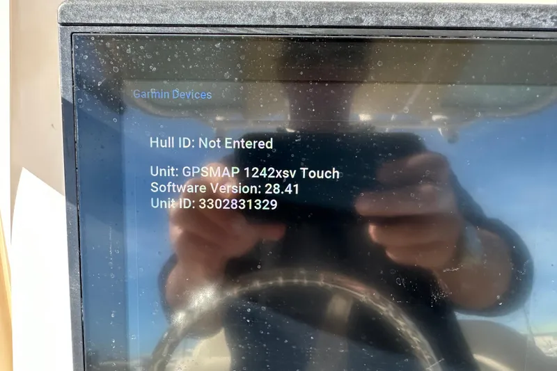 Slide: The Image of 2020 Grady-White Fisherman 236 GPS display showing Garmin device information. - 20