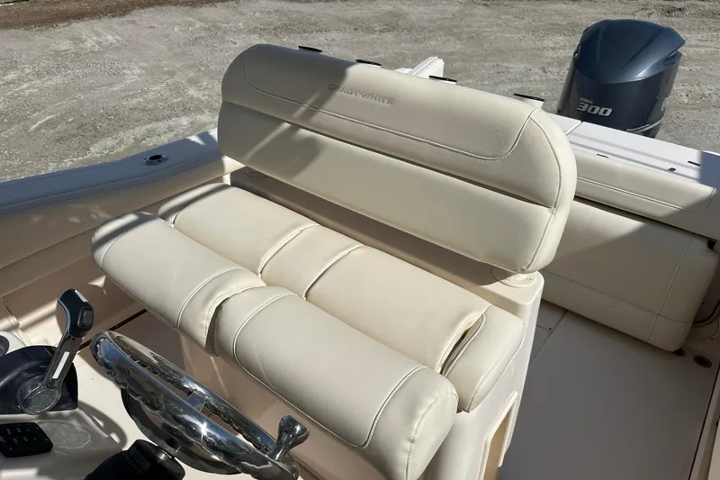 Slide: The Image of 2020 Grady-White Fisherman 236 boat interior with beige seating and steering wheel. - 24