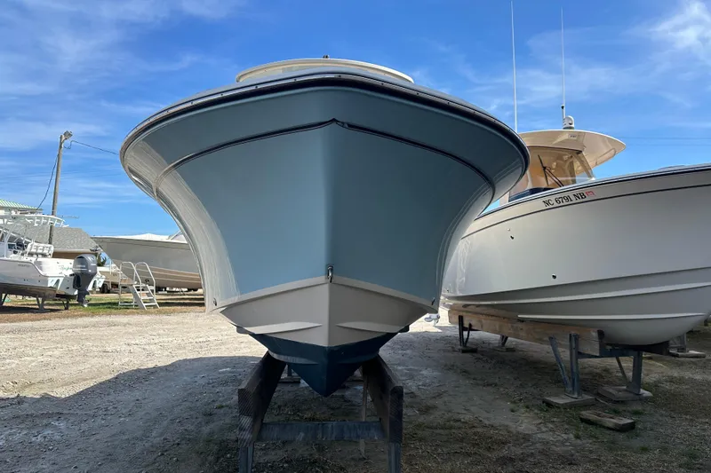 Slide: The Image of 2020 Grady-White Fisherman 236 boat on display under a clear blue sky. - 4