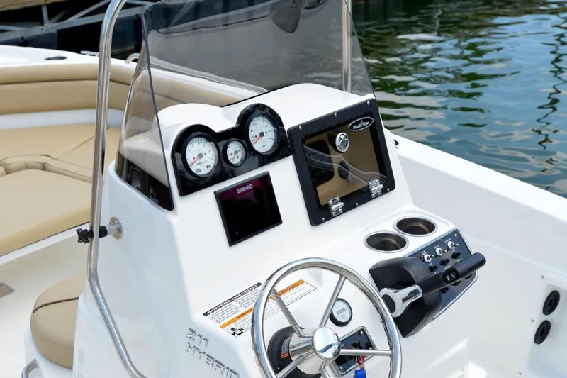 Slide: The Image of Manufacturer Provided Image: 2021 NauticStar 211 Hybrid boat console with steering wheel, gauges, and navigation screen. - 10