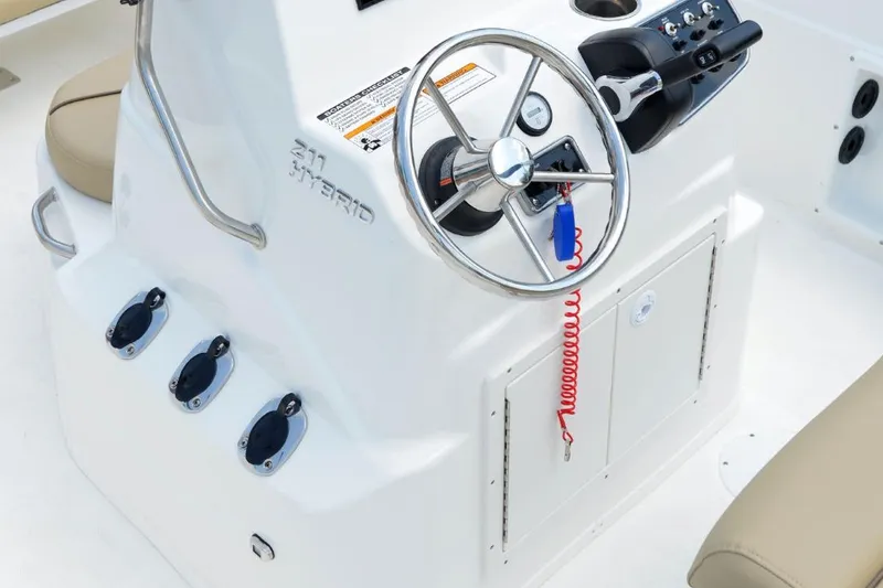 Slide: The Image of Manufacturer Provided Image: 2021 NauticStar 211 Hybrid boat console with steering wheel and controls. - 11
