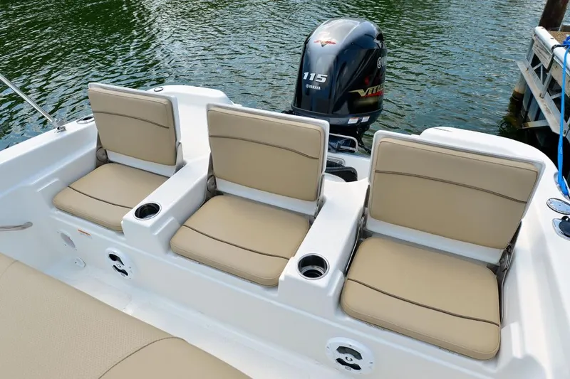Slide: The Image of Manufacturer Provided Image: 2021 NauticStar 211 Hybrid boat with beige seating and Yamaha 115 outboard motor. - 14