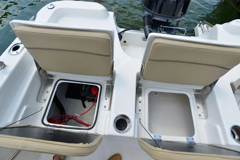 Slide: The Image of Manufacturer Provided Image: 2021 NauticStar 211 Hybrid boat with open storage compartments and seating. - 17