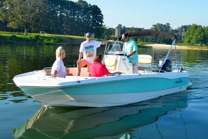 Slide: The Image of Manufacturer Provided Image: 2021 NauticStar 211 Hybrid boat with people on a calm lake. - 2