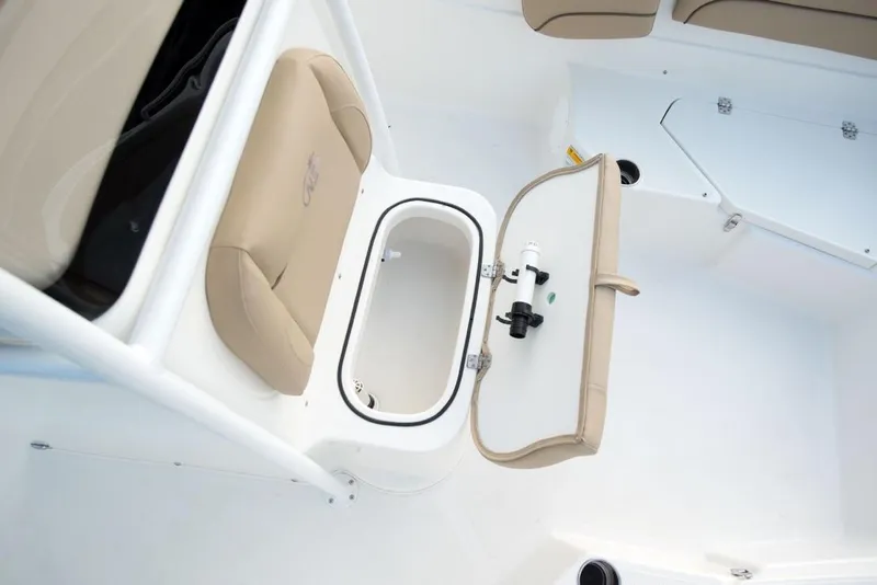 Slide: The Image of Manufacturer Provided Image: 2021 NauticStar 211 Hybrid boat with open storage compartment and beige seating. - 9
