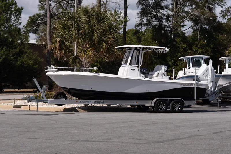 The Image of 2026 Blazer Bay Makaira 2800 boat on trailer, parked outdoors. - 1