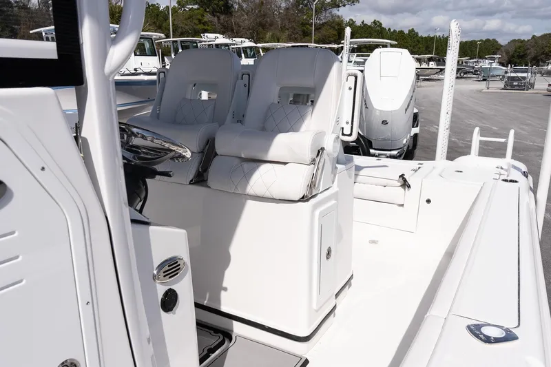 Slide: The Image of 2026 Blazer Bay Makaira 2800 boat interior with white seating and steering console. - 11