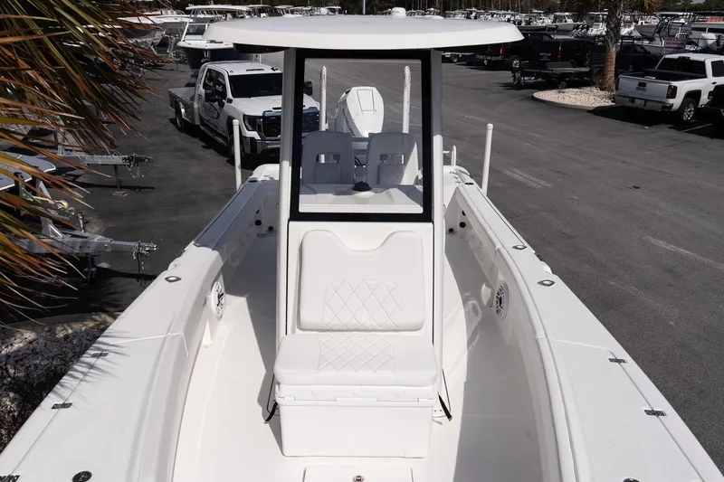 Slide: The Image of 2026 Blazer Bay Makaira 2800 boat, white interior, parked in a dealership lot. - 15
