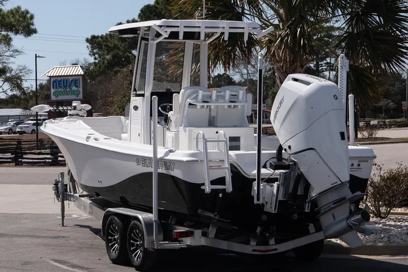 Slide: The Image of 2026 Blazer Bay Makaira 2800 boat on trailer, parked near Neuse Sport Shop. - 3