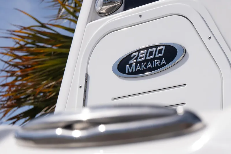 Slide: The Image of 2026 Blazer Bay Makaira 2800 boat emblem with palm tree background. - 5