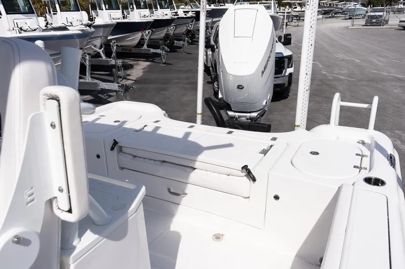 Slide: The Image of 2026 Blazer Bay Makaira 2800 boat interior with seating and storage, parked in a marina. - 6