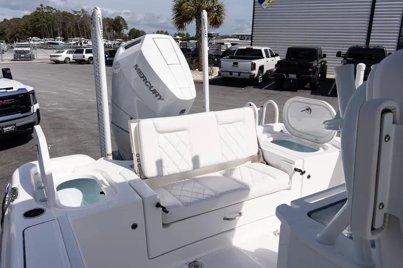 Slide: The Image of 2026 Blazer Bay Makaira 2800 boat interior with Mercury engine, white seating, and storage compartments. - 7