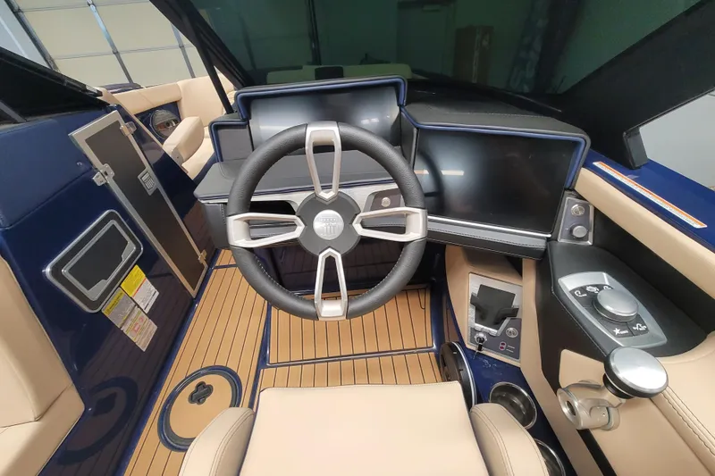 Slide: The Image of 2025 MasterCraft X24 boat cockpit with modern steering and digital controls. - 10
