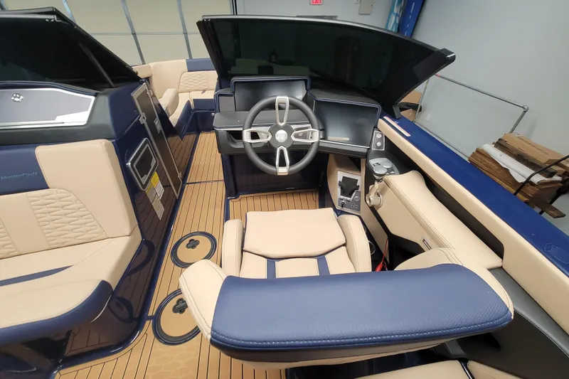 Slide: The Image of 2025 MasterCraft X24 boat interior with modern steering and luxurious seating. - 11
