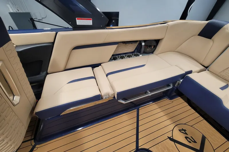 Slide: The Image of 2025 MasterCraft X24 interior with beige and blue seating, featuring cup holders and sleek design. - 15