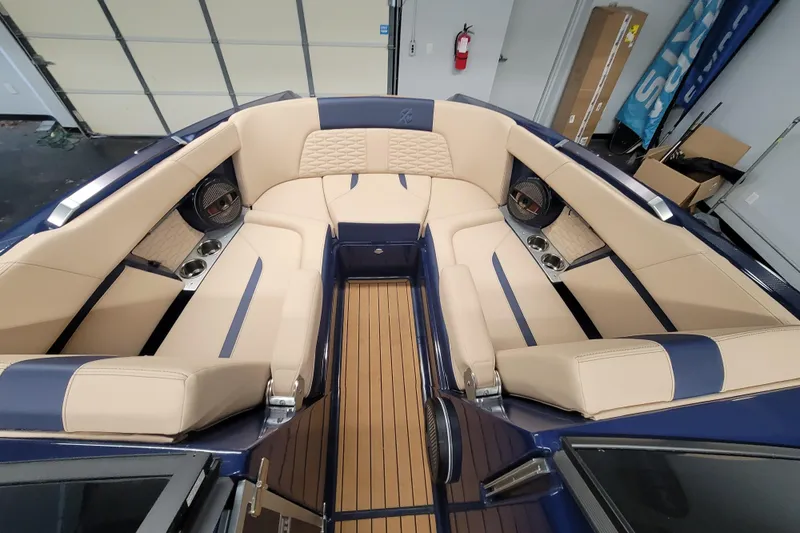 Slide: The Image of Luxurious interior of 2025 MasterCraft X24 boat with beige and blue seating. - 16