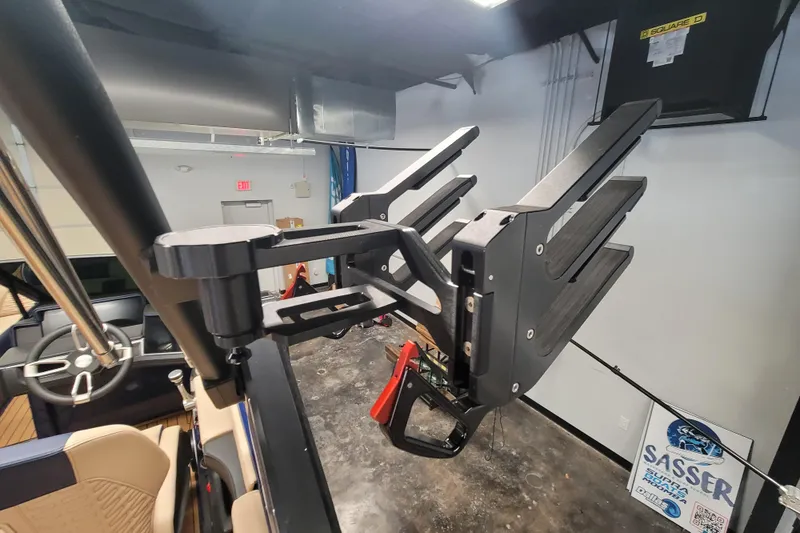 Slide: The Image of 2025 MasterCraft X24 boat interior with wakeboard rack in showroom. - 18