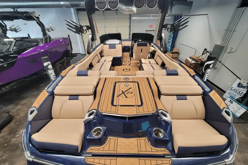 Slide: The Image of 2025 MasterCraft X24 boat interior with luxurious seating and modern design. - 9
